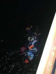 Photo of small rubber boat next to big ship