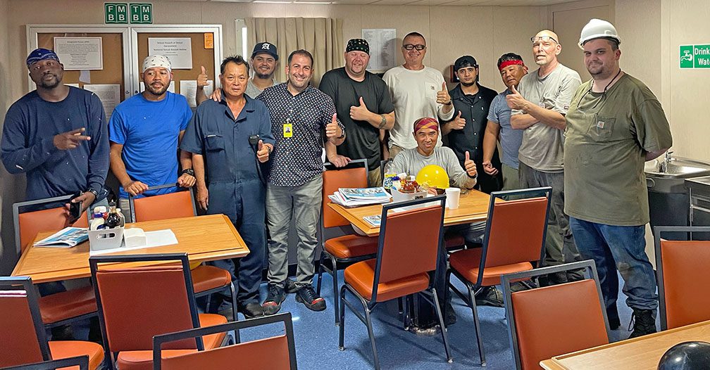 Group photo of crew members and a union official aboard new ship